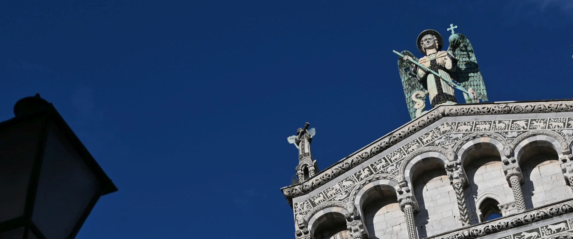 the colors of summer the angel of san michele on the facade of the church in lucca